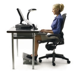 woman sitting at office desk with correct ergonomic posture